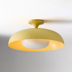 a yellow light hanging from the ceiling in a room