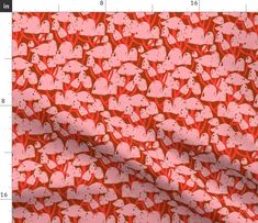 a red and white pattern with hearts on it, as well as a ruler for measurements