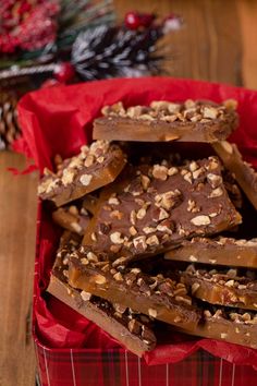 a red basket filled with chocolate and nuts