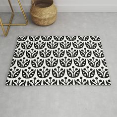 a black and white rug on the floor next to a basket