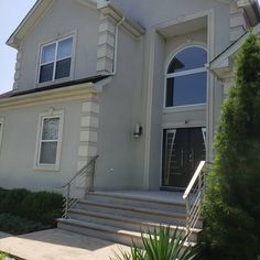 a house with stairs leading up to the front door