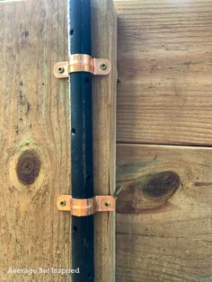 a close up of a wooden door with metal handles