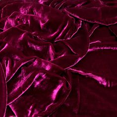 a pile of red velvet sheets on top of each other