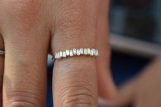 a woman's hand with a diamond ring on it