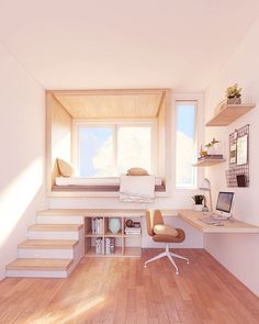 a room that has some stairs and a desk with a laptop on it in front of a window