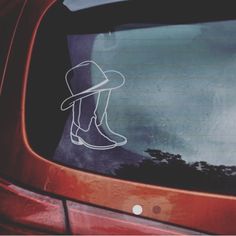 a hat and boots sticker on the side of a car's rear window