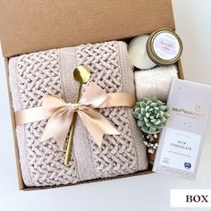 an open box containing candles, soaps and other items