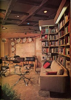 a living room filled with lots of books and furniture