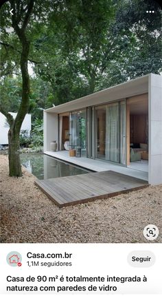 an image of a house in the woods with trees and water on it's side