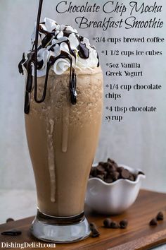 there is a chocolate drink with whipped cream and chocolate chips in it on the table