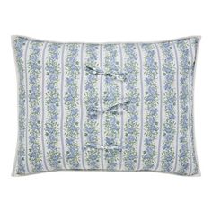 a blue and white striped pillow with flowers on the front, two ruffled edges