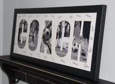 a black and white photo with the word coach written in multiple letters on it, framed above a mantle