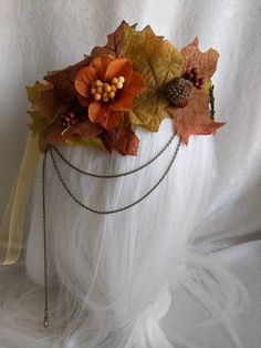 The sun sets on the horizon, tingeing the sky with warm orange light. As twilight sets in, the wind causes the fall foliage to scatter upon the ground; a beautiful autumn sunset marks the start of the harvest. This gorgeous tiara features rust and olive-colored autumn leaves, acorns, and berries. Two branches adorn the bronze charm with a rust colored crystal in the center, and three rust drop crystals hang from the charms like ripe autumn fruit. Bronze chains decorate each side of the piece wit Fall Costume Autumn, Fall Crown, Fall Costume, Crown Fairy, Autumn Fruit, Autumn Sunset, Leaf Crown, Antler Headband, Ren Fair