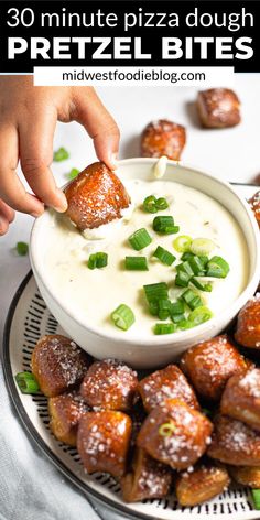 a person dipping some food into a bowl with green onions on it and the words, 30 minute pizza dough pretzel bites