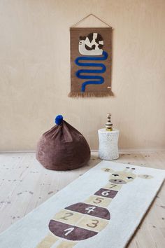 a white rug sitting on top of a wooden floor next to a bag and bottle