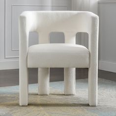 a white chair sitting on top of a rug