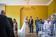 a bride and groom walking down the aisle at their wedding ceremony in front of an audience