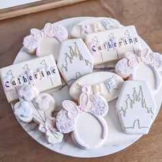 decorated cookies are arranged on a plate with name tags and other decorative items in the shape of mice