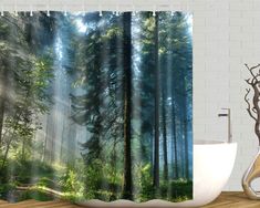 a shower curtain with trees in the background and sunlight coming through it, on a wooden floor