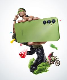 a man holding a green cell phone in the air with other objects surrounding him and on top of it