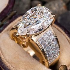 a gold ring with a large diamond in it