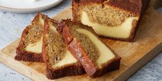 slices of cake sitting on top of a wooden cutting board