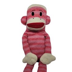 a stuffed monkey is wearing a red and white striped outfit with black eyes, nose, and hands