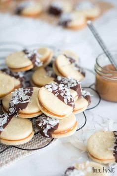 cookies with chocolate and coconut on a plate next to a jar of nutellas