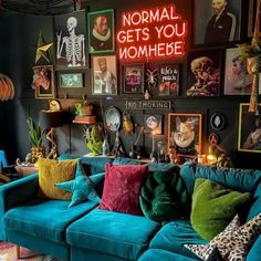 a living room filled with blue couches and lots of pictures on the wall above them