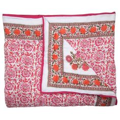 two pink and white pillows with red trims on each pillow cover, one has an orange flower design