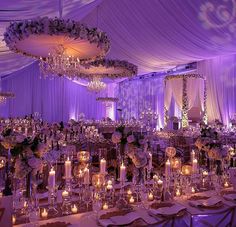 the tables are set up with candles and centerpieces for an elegant wedding reception