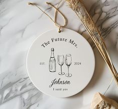 a personalized ceramic ornament with two wine glasses