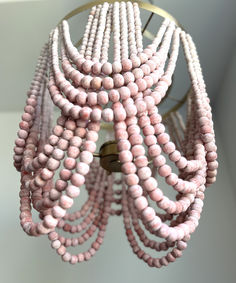 a pink beaded chandelier hanging from a ceiling