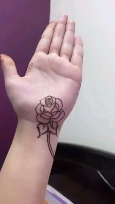 a woman's hand with henna tattoos on it