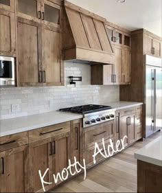 a kitchen with wooden cabinets and white counter tops in front of a window that reads knotty alder