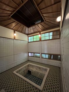 an empty room with tiled floors and walls