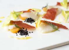 small appetizers are arranged on a white plate