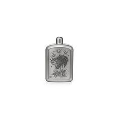 a silver flask with an image of a dragon on it