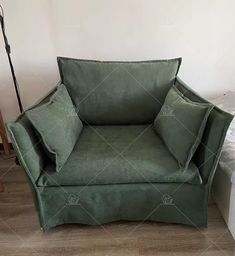 a green chair sitting on top of a hard wood floor