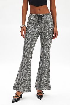 Ecote pant in a bootcut silhouette you’re sure to go wild for! Designed in a sleek, snake-printed faux leather featuring a low-rise pull-on waistline, lace-up detailing and side pockets. Exclusively at Urban Outfitters. Features Ecote Monty snakeskin low rise bootcut pant Faux leather pant Snake print faux leather Low-rise pull-on waistline Lace-up detailing at the fly Side pockets Bootcut silhouette Full length Easy pull-on style UO exclusive Content + Care 100% Polyester Machine wash Imported Size + Fit Model in Brown Multi is 5’11" and wearing size Small Measurements taken from size Small Inseam: 32" | Ecote Monty Snakeskin Low Rise Bootcut Pant in Snake Print, Women's at Urban Outfitters 2025 Predictions, Snake Skin Pants, Leather Pant, Bootcut Pants, Go Wild, Street Wear Urban, Faux Leather Pants, The Fly, Snake Print