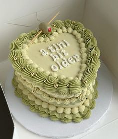 a heart shaped cake with the words happy birthday on it