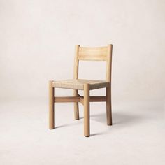 a wooden chair sitting on top of a white floor