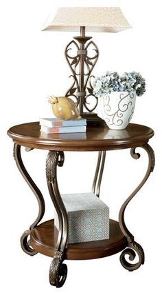 Nestor End Table T517-6 Stationary Occasionals By ashley - sofafair.com Round End Table, Oval Coffee Tables, Ashley Furniture Homestore, Living Room End Tables, Console And Sofa Tables, Acanthus Leaf, Ashley Furniture, Beautiful Table, Medium Brown