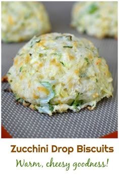 zucchini drop biscuits on a baking sheet with the words warm, cheesy goodness