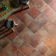 an overhead view of two stools on a tiled floor