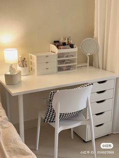 a white desk with drawers and a chair next to it in front of a window