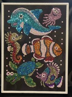 an image of sea animals made out of sequins on a black background with white border