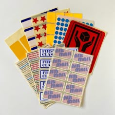 various stickers and decals on a white surface, including one for the mailman