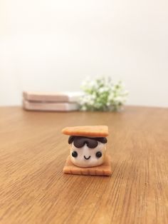 a small figurine is sitting on a wooden table