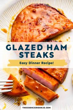 glazed ham steaks on a white plate with a fork and knife next to it